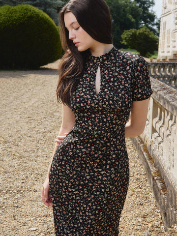 Elevate your wardrobe with this stunning vintage-inspired dress that effortlessly transitions from boardroom to celebration. The classic black base paired with delicate floral detailing creates an understated elegance, while the high neckline adds a touch of sophistication and polish. Perfect for making a memorable impression at the office or turning heads at homecoming, this piece proves that timeless style never goes out of fashion. Versatile, flattering, and undeniably chic—your new go-to dress awaits.