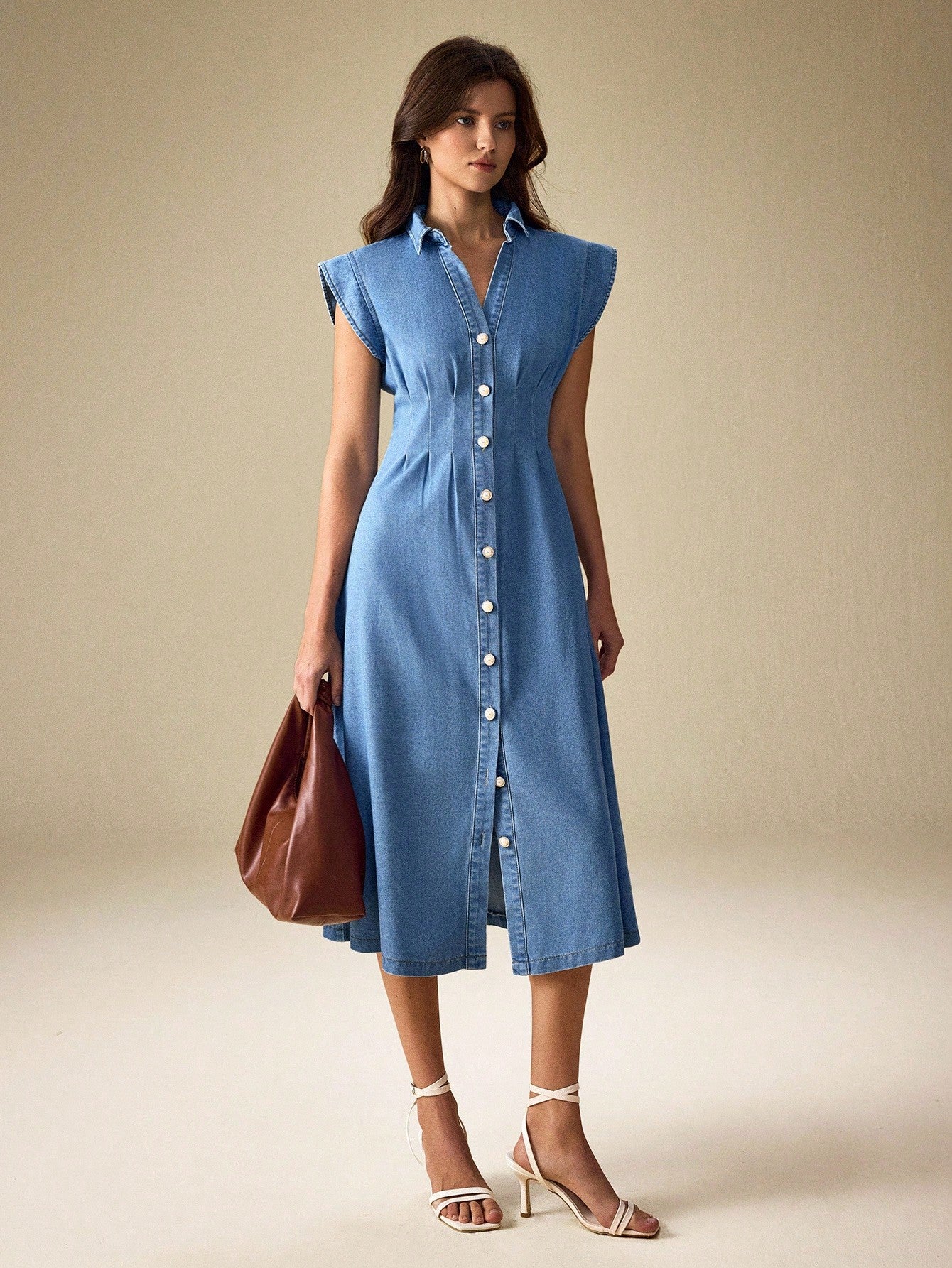 Effortlessly cool meets timeless charm in this vintage-inspired denim dress. Designed for the modern commuter who refuses to sacrifice style for comfort, it features classic front button detailing that adds character and makes dressing up (or down) a breeze. The relaxed silhouette works beautifully with sneakers for weekend errands or dressed up with boots for casual office days. Perfect for anyone who loves that "I just threw this on" vibe—except you totally planned it. Versatile, comfortable, and undeniab