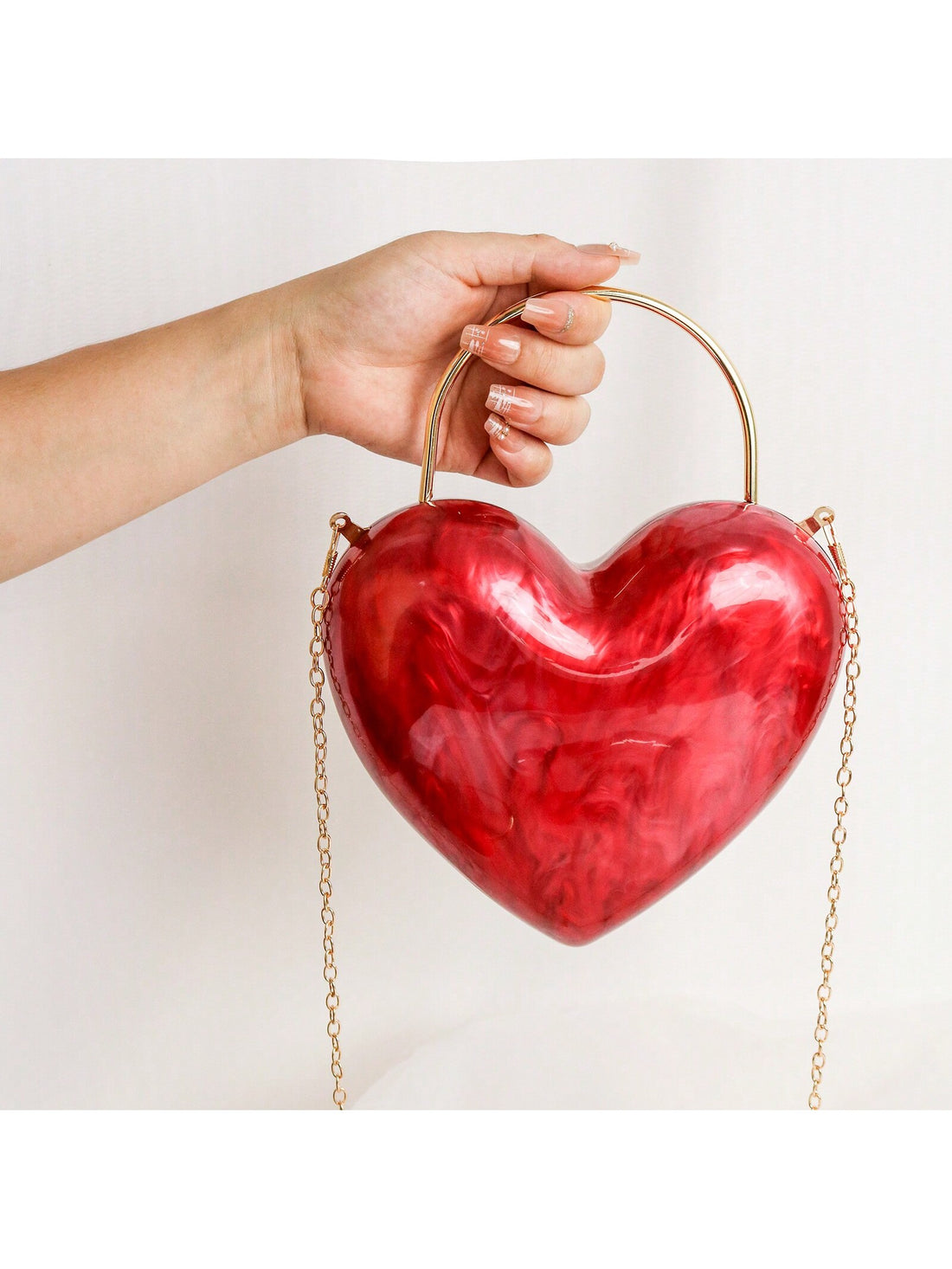 Elevate your style with our Chic Vintage Heart-Shaped Acrylic Clutch! Perfect for parties and special occasions, this stunning clutch adds a touch of elegance to any outfit. With its unique heart shape and vintage design, it's sure to turn heads. Make a statement and stand out from the crowd with this must-have accessory!