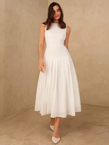 Elevate your seasonal wardrobe with this sophisticated white sleeveless dress, designed for effortless elegance. The flowing silhouette features a refined pleated hem that adds movement and visual interest, while the sleeveless cut keeps you cool during warm months. Crafted for versatility, this piece transitions seamlessly from casual daytime wear to evening occasions. The clean white palette pairs beautifully with layered accessories or statement jewelry, making it an essential investment for spring and s