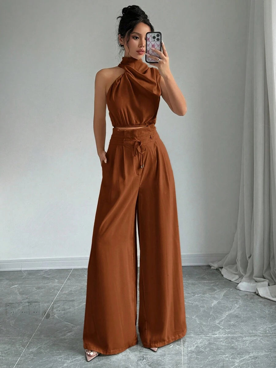 Elevate your office wardrobe with this sophisticated 2-piece set featuring a sleeveless turtleneck crop top paired with wide-leg pants. Crafted from 100% polyester woven fabric, this ensemble delivers an elegant, polished look perfect for professional settings. The top showcases an asymmetrical neckline with lace-up detailing, while the pants feature a convenient pocket and zipper closure for everyday functionality. In classic navy blue with a regular fit, this versatile set transitions seamlessly.