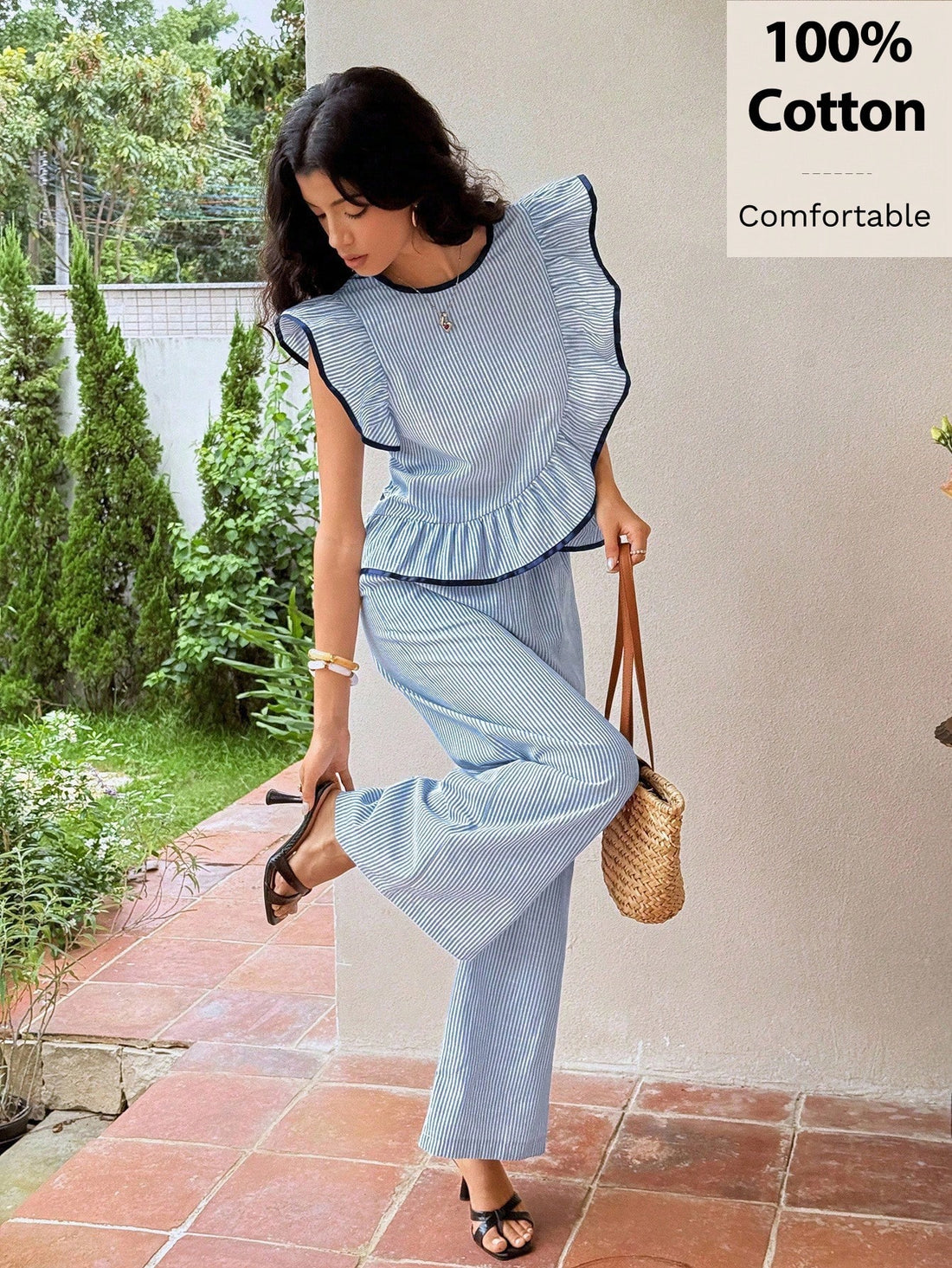 Elevate your seasonal wardrobe with this charming two-piece set that's equal parts sophisticated and fun. The crisp blue and white striped sleeveless top features delicate frill-cut details that add a playful touch, while the relaxed wide-leg pants offer comfort without compromising style. Crafted from breathable 100% cotton, this pairing transitions seamlessly from casual outings to weekend gatherings. Perfect for layering through fall and winter, it's the effortless ensemble that makes getting dressed fee