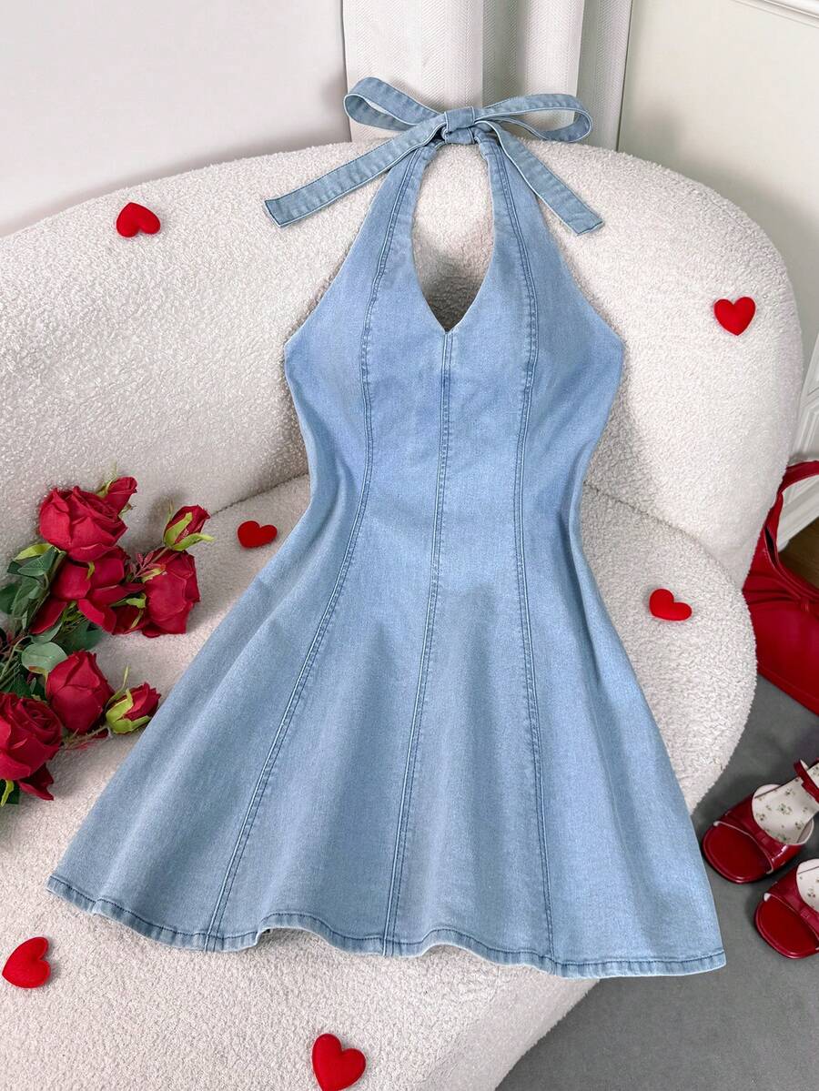 Elevate your wardrobe with this chic halter neck denim mini dress. The flattering halter design creates a sophisticated silhouette while the classic denim fabric offers timeless style and durability. Perfect for Valentine's Day dates, summer outings, or casual weekend adventures, this versatile piece transitions effortlessly from day to night. The mini length showcases your legs while maintaining an elegant aesthetic. 