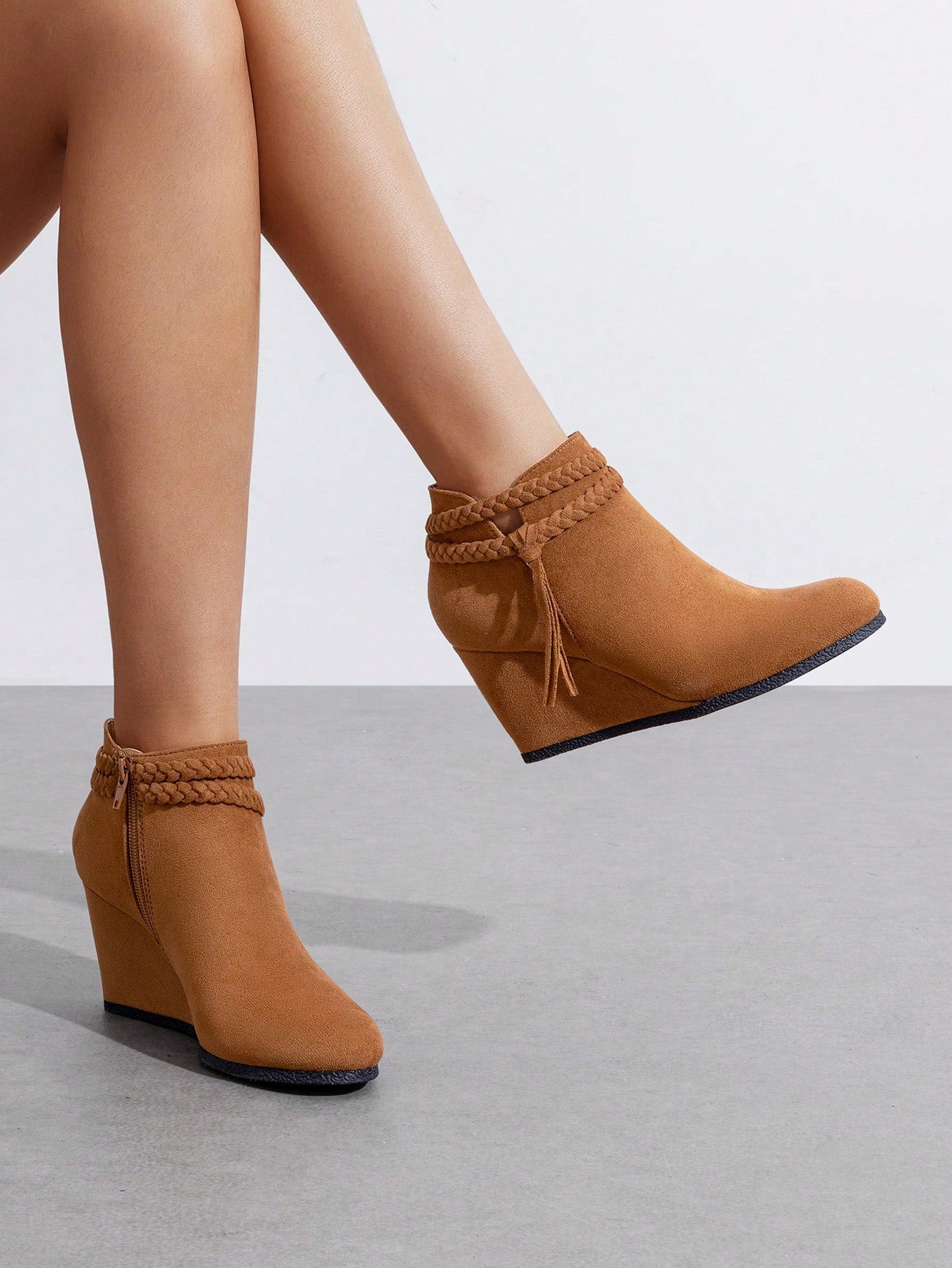 Step up your style game with these chic high wedge ankle boots designed for the bold and playful woman. Featuring charming braided straps and playful tassels, they bring personality and flair to any outfit. The high wedge provides extra height without sacrificing comfort, making them perfect for all-day wear. These boots are the ideal blend of fun and function, crafted to keep you looking fabulous wherever you go.