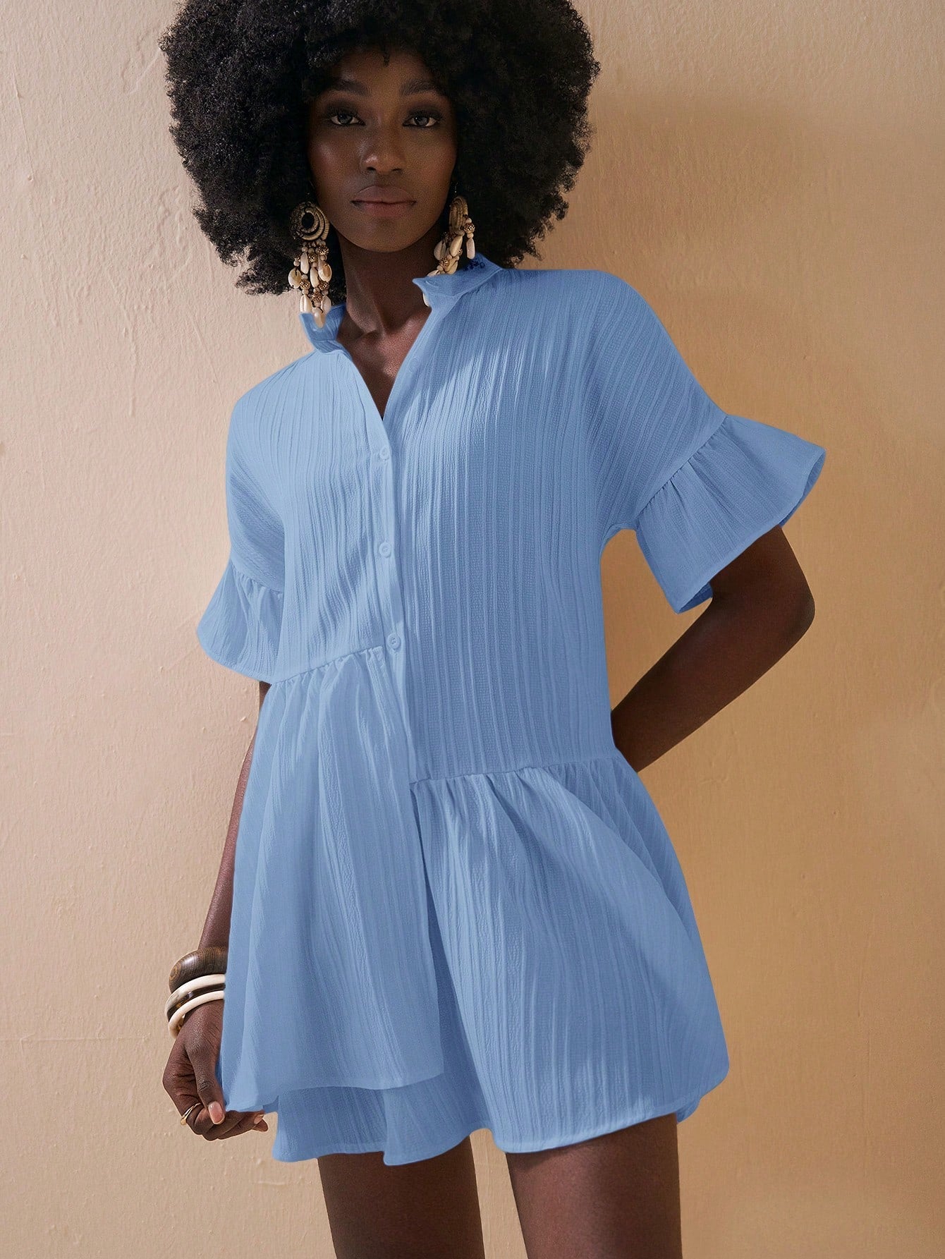Step into sunshine with this playful mini dress featuring a flirty asymmetrical hem and charming ruffled sleeves. Perfect for spring and summer getaways, it combines effortless style with a breezy feel, making every vacation moment feel light and fun.