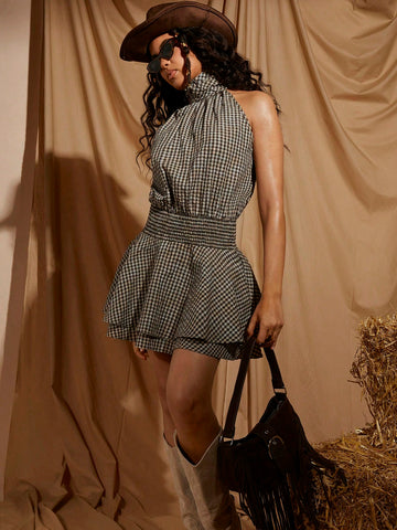 Turn heads in this stunning plaid halter neck mini dress that effortlessly blends sophistication with fun. The flattering gathered waist cinches your silhouette while the classic plaid pattern adds timeless charm. Whether you're heading to brunch, a night out, or a casual gathering, this versatile piece transitions seamlessly from day to night. The halter neckline offers a chic, modern touch that's sure to make a statement. Comfortable, stylish, and endlessly wearable—your new go-to dress awaits!