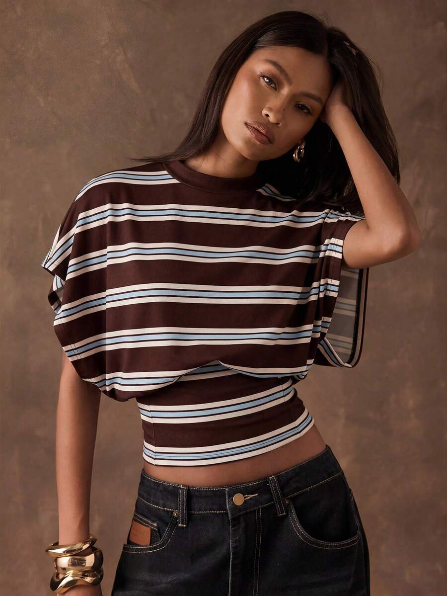 Effortless style meets playful charm in this women's polka dot batwing sleeve tee. The relaxed batwing sleeves create a flattering silhouette while the cinched waist defines your figure beautifully. Classic polka dot pattern adds timeless appeal to any casual wardrobe. Perfect for layering or wearing solo, this versatile piece transitions seamlessly from day to night. Soft, comfortable fabric keeps you feeling great all day long.
