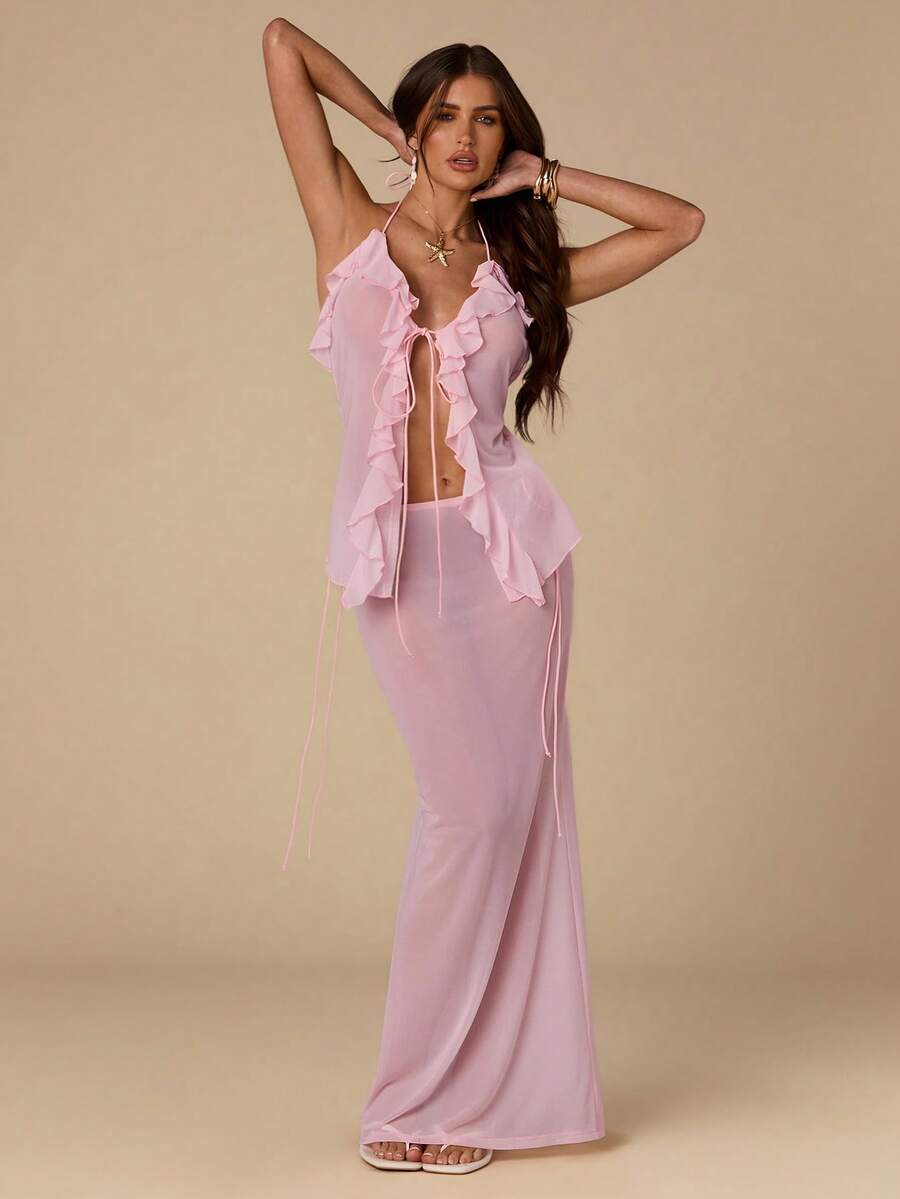 Elevate your warm-weather wardrobe with this stunning two-piece set featuring a flattering halter top with delicate ruffle trim and a coordinating mini skirt. The halter neckline offers adjustable support and a chic silhouette, while the ruffled details add playful texture and movement. Perfect for music festivals, beach getaways, or casual summer outings, this set combines style with comfort.