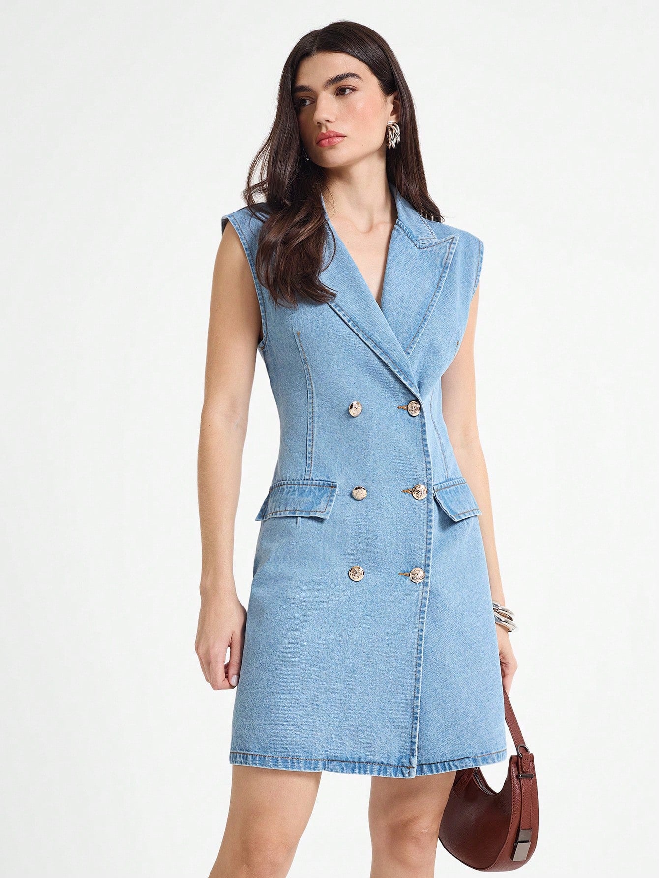 Step out in style with this chic sleeveless denim dress featuring a double-breasted lapel design. Perfect for sunny days or layering up, it combines casual comfort with a dash of sophistication. Whether you're brunching with friends or exploring the city, this dress adds a playful twist to your wardrobe essentials.