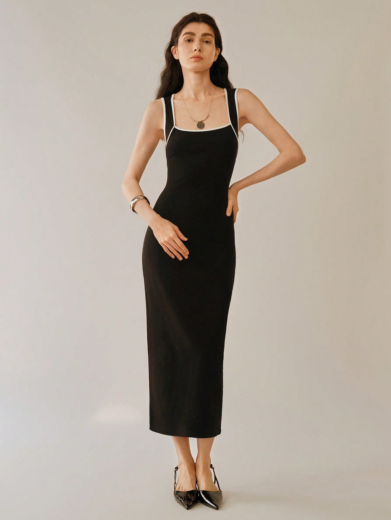 Add some playful edge to your wardrobe with our Chic Women's Sleeveless Knitted Dress! Featuring a stylish cutout back and a bold black and white color block design, this dress is perfect for any occasion. So go ahead, make a statement and rock this unique and fun dress.
