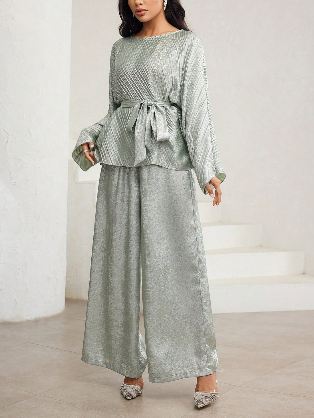 Effortlessly chic meets comfy-cozy with this fabulous two-piece set! The bat sleeve shirt drapes beautifully with its flowy, dramatic sleeves that add instant flair to your everyday look. Pair it with the wide-leg pants for a silhouette that's both flattering and oh-so-relaxed. Perfect for lounging at home, casual outings, or those days when you want to look put-together without trying too hard. Available in versatile solid colors that mix and match with your existing wardrobe. Your new go-to set for laid-b