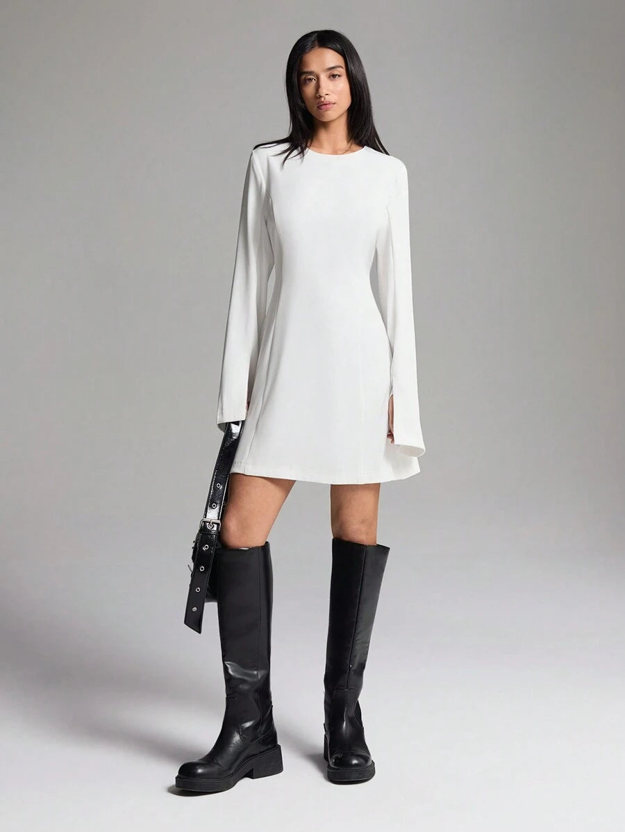 Step out in style with this chic solid color dress designed for effortless elegance. Featuring a flattering round neck and a playful side slit, it adds a touch of fun to your casual look. The long sleeves keep it cozy while maintaining a sleek silhouette, perfect for day-to-night wear. Embrace comfort and charm in one fabulous dress!