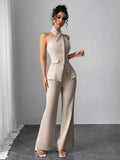 Elevate your wardrobe with this sophisticated 2-piece set featuring a sleek halter camisole and flowing flare pants. The backless halter top offers a modern, elegant silhouette perfect for office settings or special occasions, while the high-waisted flare pants provide a flattering, timeless look. Crafted from a comfortable 95% polyester and 5% elastane blend, this set moves with you throughout your day. The neutral apricot tone pairs effortlessly with accessories for versatile styling.