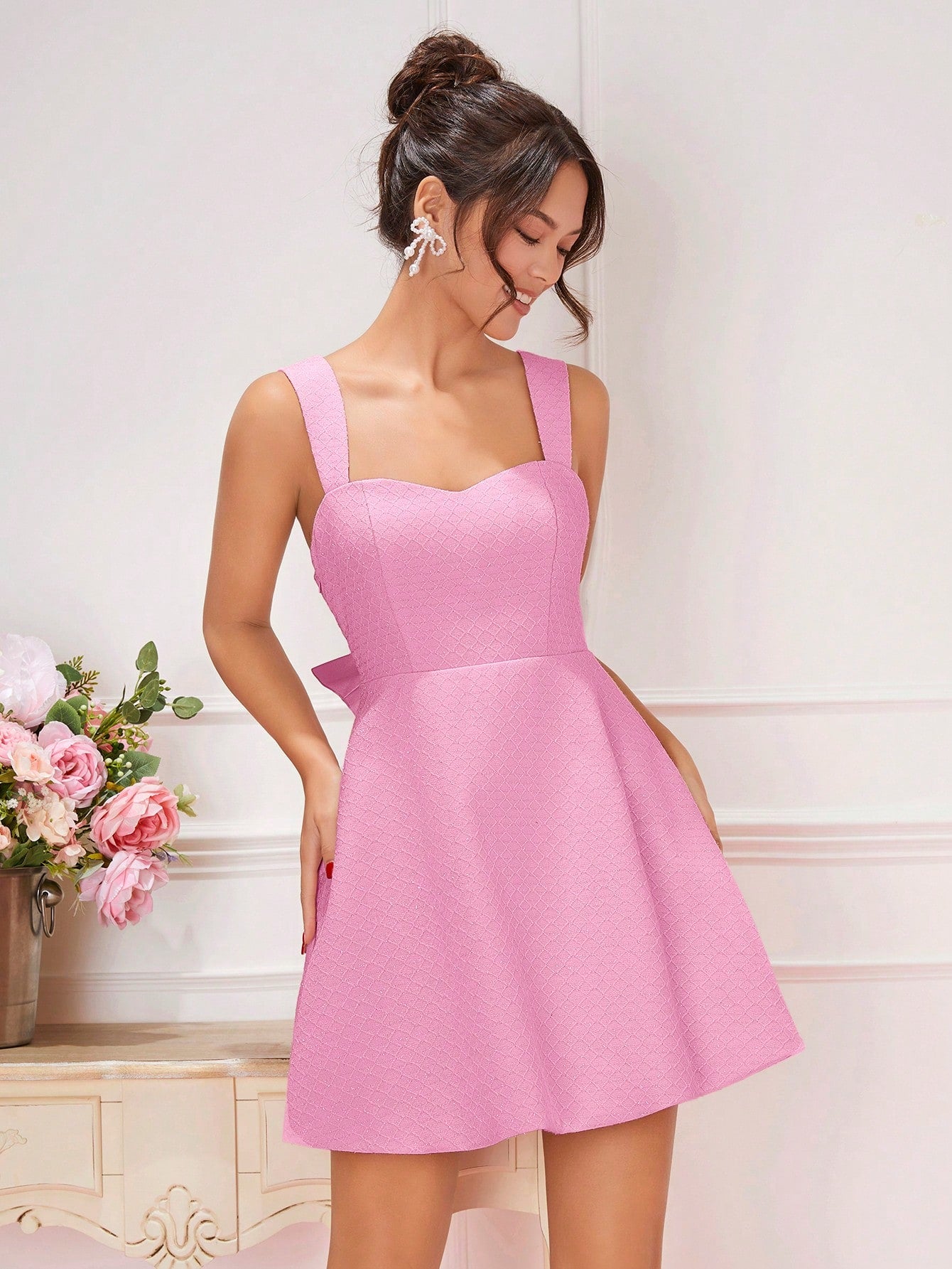 This dress is perfect for summer days with its chic backless design and elegant bow detail. The spaghetti straps add a touch of delicacy, making you feel like the most fashionable woman in the room. Stay cool and stylish this season with this unique dress.