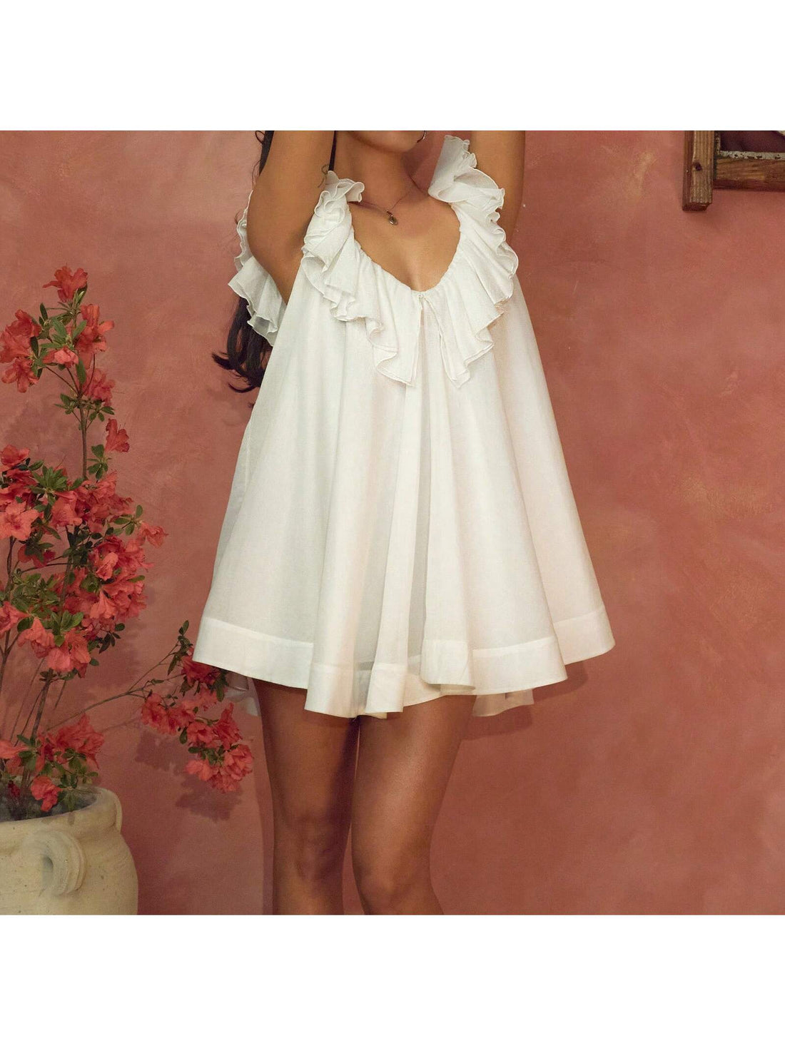 Effortless summer style meets playful elegance in this charming mini dress. The sleeveless V-neck design flatters your silhouette while ruffled details add a touch of whimsy and movement. Crafted with a flowy, swing cut, it's perfect for breezy days, casual outings, or spontaneous adventures. Whether you're heading to brunch, the beach, or a weekend getaway, this versatile piece transitions seamlessly from day to night. Slip it on and let the good vibes flow.