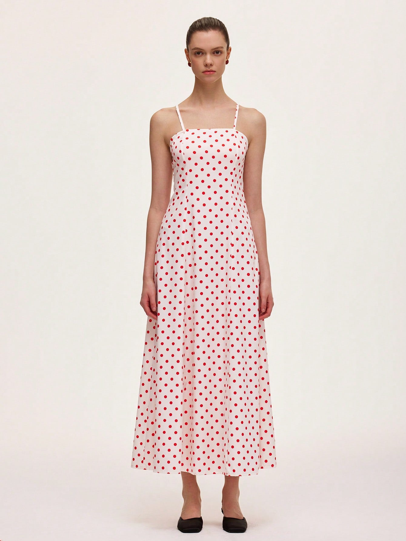 This playful polka dot cami midi dress is designed to flatter your figure with a waist-cinching silhouette that adds a touch of charm to your look. Its breezy midi length and delicate straps make it perfect for effortless style, whether you're out for brunch or dancing the night away. Embrace fun and feminine vibes with this chic wardrobe staple.