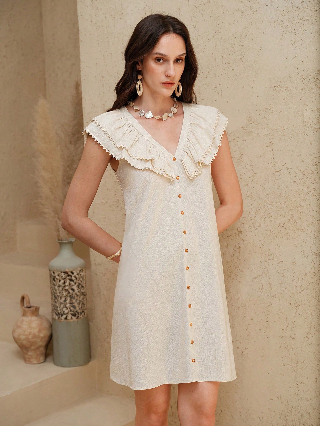 Breeze through vacation days in this playful linen dress! The flutter sleeves add a flirty touch, while the ruffled trim frames the flattering V-neck perfectly. Lightweight and airy, this woven wonder transitions effortlessly from beachside brunches to sunset strolls. Your suitcase's new best friend!