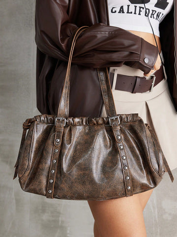 Effortlessly elevate your modern style with our Chic Y2K Vintage Rivet Hobo Bag. Its versatile design and trendy rivet detailing add a touch of sophistication to any outfit. With this stylish shoulder bag, you'll make a statement while staying organized and on-trend.