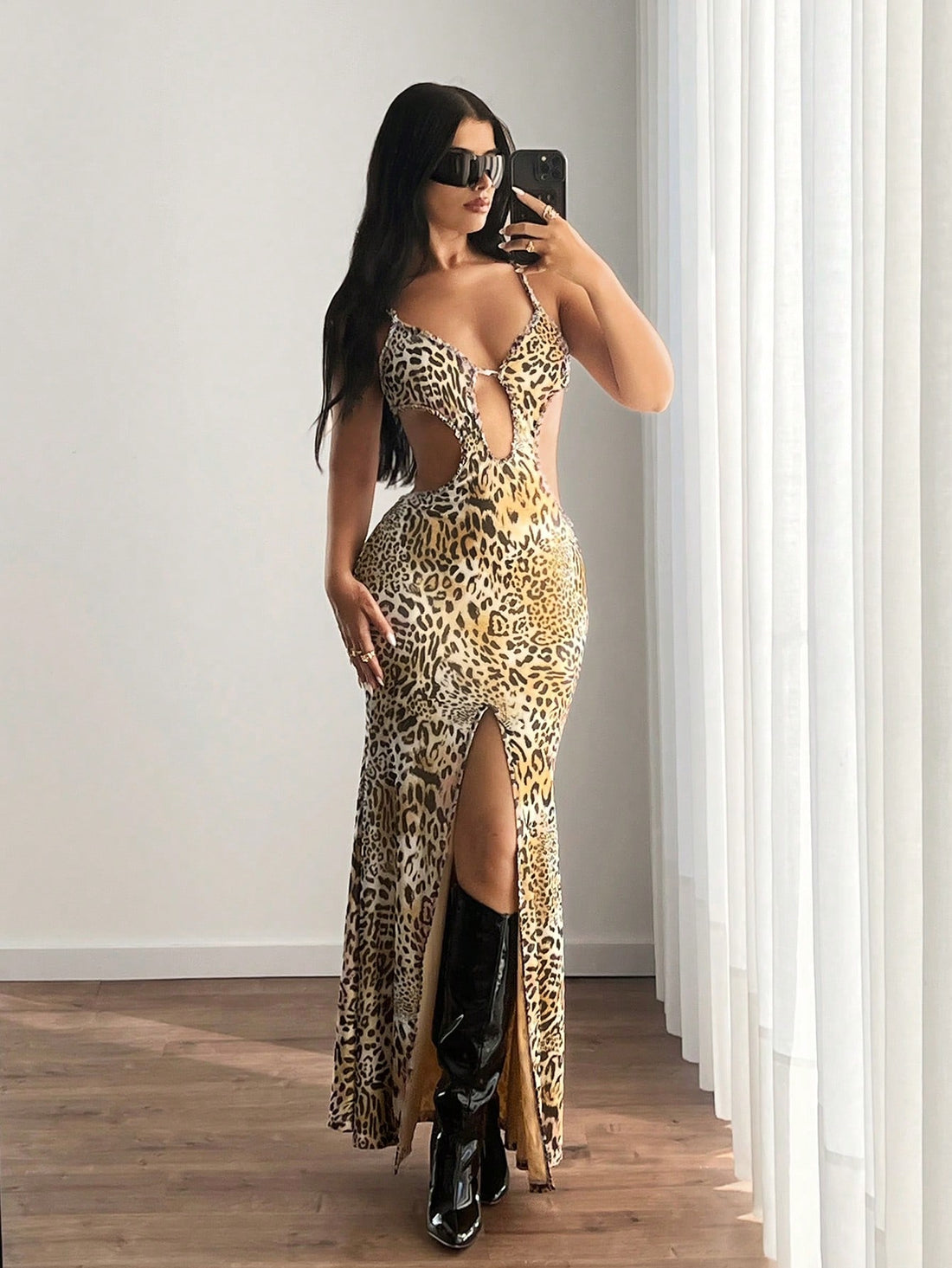 Step into Y2K nostalgia with this leopard print slip dress that's equal parts sultry and fun. The delicate spaghetti straps keep things effortless while the split hem adds a flirty edge perfect for showing off your favorite boots or sneakers. Whether you're layering it over a fitted tee or going solo, this versatile piece brings that coveted early-2000s vibe to your fall wardrobe. Dress it up for nights out or down for casual weekend vibes—this leopard beauty does it all.