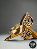 Side product view of metallic gold open-toe mule sandals with wide vamp and hollow circular sculptural heel