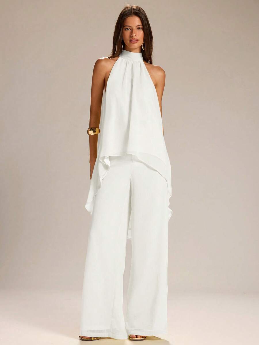 Elevate your warm-weather wardrobe with this effortless two-piece set. The sleeveless halter neck tank top in vibrant yellow pairs perfectly with lightweight linen wide-leg pants, creating a breezy silhouette ideal for spring and summer days. The halter neckline adds a touch of sophistication while keeping you cool, while the flowing pants offer comfort and movement. Whether you're heading to brunch, a casual outing, or a relaxed evening, this coordinated set delivers laid-back style with modern appeal. 