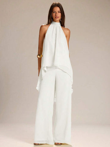 Elevate your warm-weather wardrobe with this effortless two-piece set. The sleeveless halter neck tank top in vibrant yellow pairs perfectly with lightweight linen wide-leg pants, creating a breezy silhouette ideal for spring and summer days. The halter neckline adds a touch of sophistication while keeping you cool, while the flowing pants offer comfort and movement. Whether you're heading to brunch, a casual outing, or a relaxed evening, this coordinated set delivers laid-back style with modern appeal. 