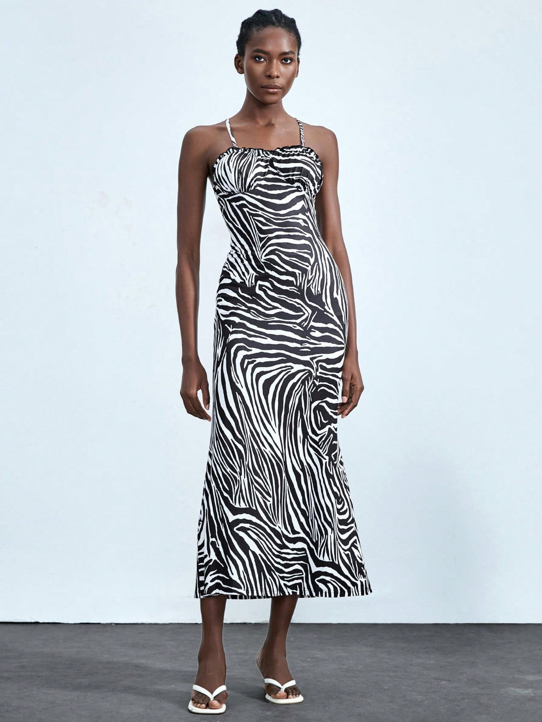 Add some playful pizzazz to your wardrobe with this Chic Zebra Print Midi Dress! Featuring charming ruffled straps, this dress is perfect for adding a touch of sophistication to your summer style. Embrace your wild side and stand out from the crowd with this fun and flirty dress.