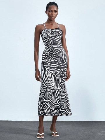 Add some playful pizzazz to your wardrobe with this Chic Zebra Print Midi Dress! Featuring charming ruffled straps, this dress is perfect for adding a touch of sophistication to your summer style. Embrace your wild side and stand out from the crowd with this fun and flirty dress.