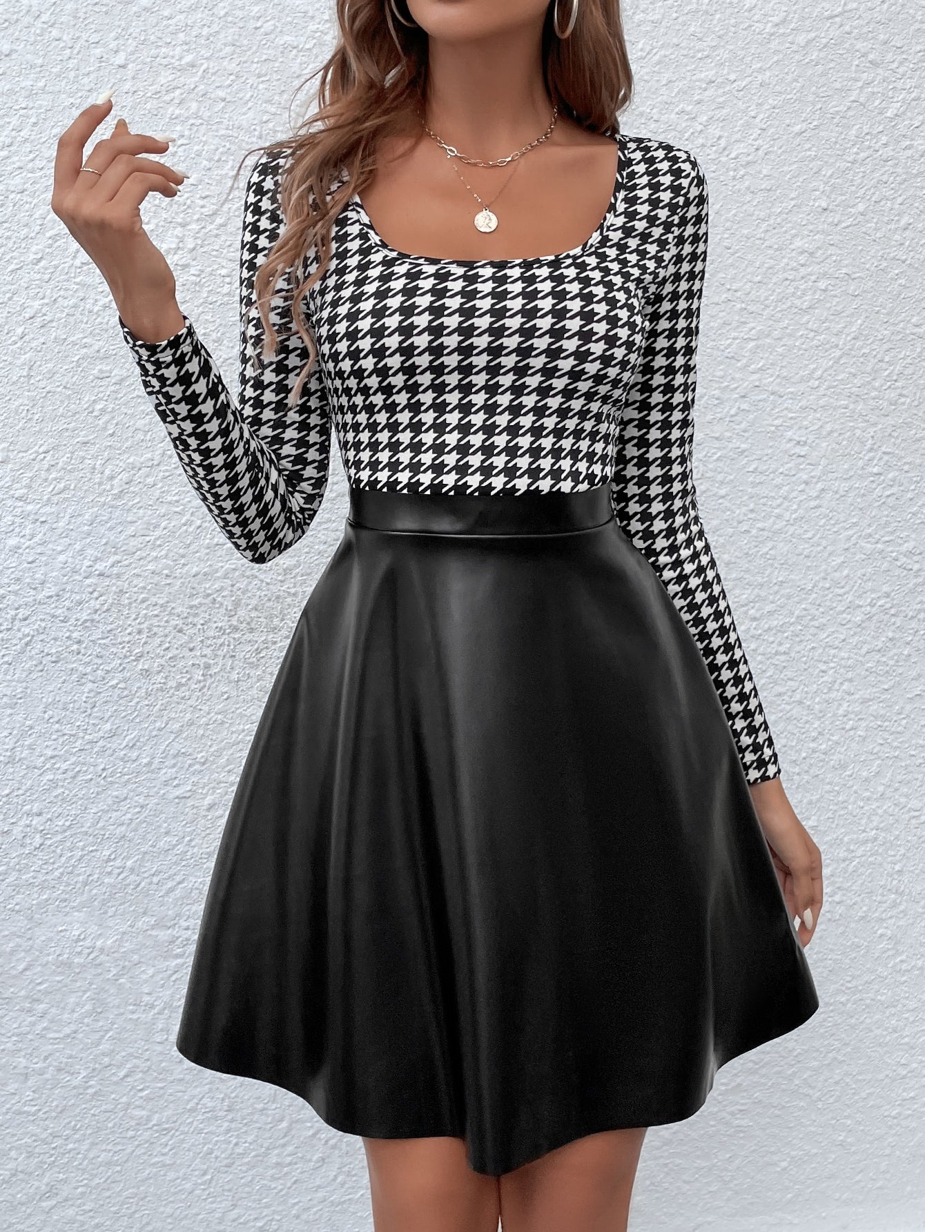 Make a statement with our Chic and Classic Houndstooth Print Dress. The timeless houndstooth pattern is complemented by a flattering scoop neck and contrast PU details. This dress is perfect for both work and play and is sure to turn heads. Upgrade your wardrobe with this chic and classic piece.