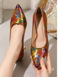 Tan glossy pointed toe pumps with multicolor graffiti print and gold flared heels shown close-up