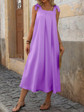 This chic and simple dress is the perfect addition to any summer vacation wardrobe. Made with comfortable spaghetti straps and a pleated design, this dress offers effortless style and elegance. With its solid color, it can be easily dressed up or down for any occasion. Enjoy the warm weather in style with this versatile dress.