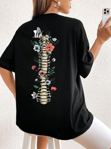 Introducing the Chic and Spooky: Floral Skeleton Print Drop Shoulder Tee. This t-shirt boasts a unique floral skeleton print, perfect for adding a touch of edge to any outfit. Its drop shoulder design offers a fashionable and comfortable fit. Get ready to stand out with this chic and spooky tee.