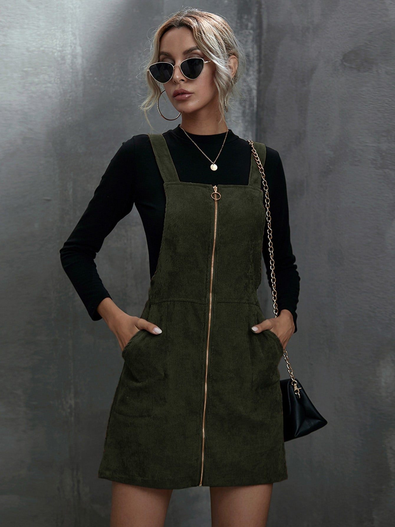 Stay on trend with our Chic and Stylish O-ring Zip-Up Corduroy Overall Dress. Featuring a modern O-ring zip-up closure and chic corduroy fabric, this dress is both fashionable and functional. Perfect for a stylish day out, this dress is a must-have for any fashion-forward individual.