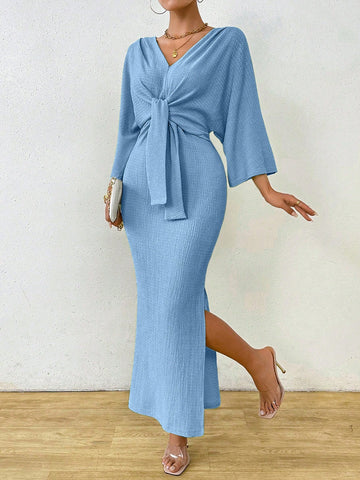 Step out in playful style with the Clasi Women's Minimalist Solid Color Front Tie Long Sleeve Maxi Dress. This quirky dress features a front tie and a slit for added fun and fashion. Its minimalist design is perfect for any occasion, making you stand out in the most playful way possible. (No pun intended!)