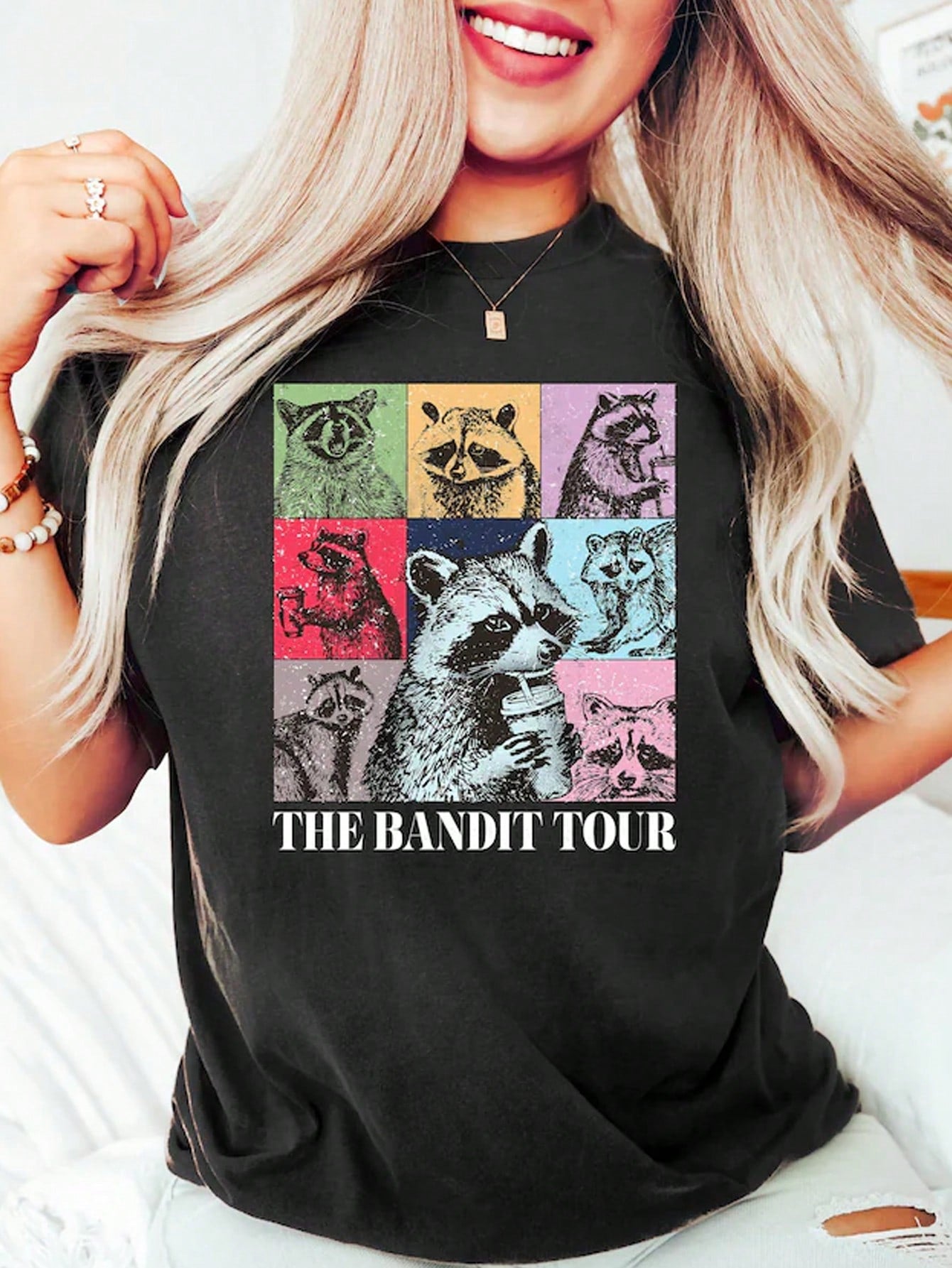 This Coffee-Loving Raccoon Graphic Tee features a fun and quirky design, perfect for any coffee-loving woman. Made from comfortable fabric, this t-shirt is a must-have for any casual outfit. Show off your love for coffee and your unique style with this graphic tee.