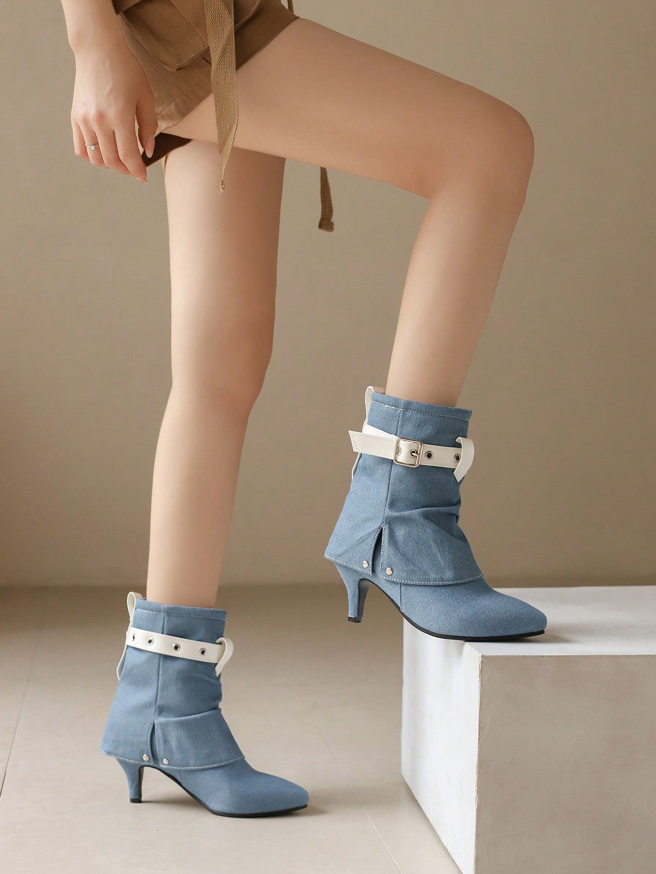 Elevate your fall/winter style with our Color Block Belt Buckle High Heel Boots. These versatile must-haves offer a perfect balance of fashion and function, featuring a color block design and chic buckle accents. Step up your shoe game with confidence and comfort in every step.