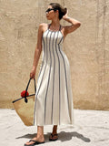 Front view of ivory halter maxi dress with black vertical piping