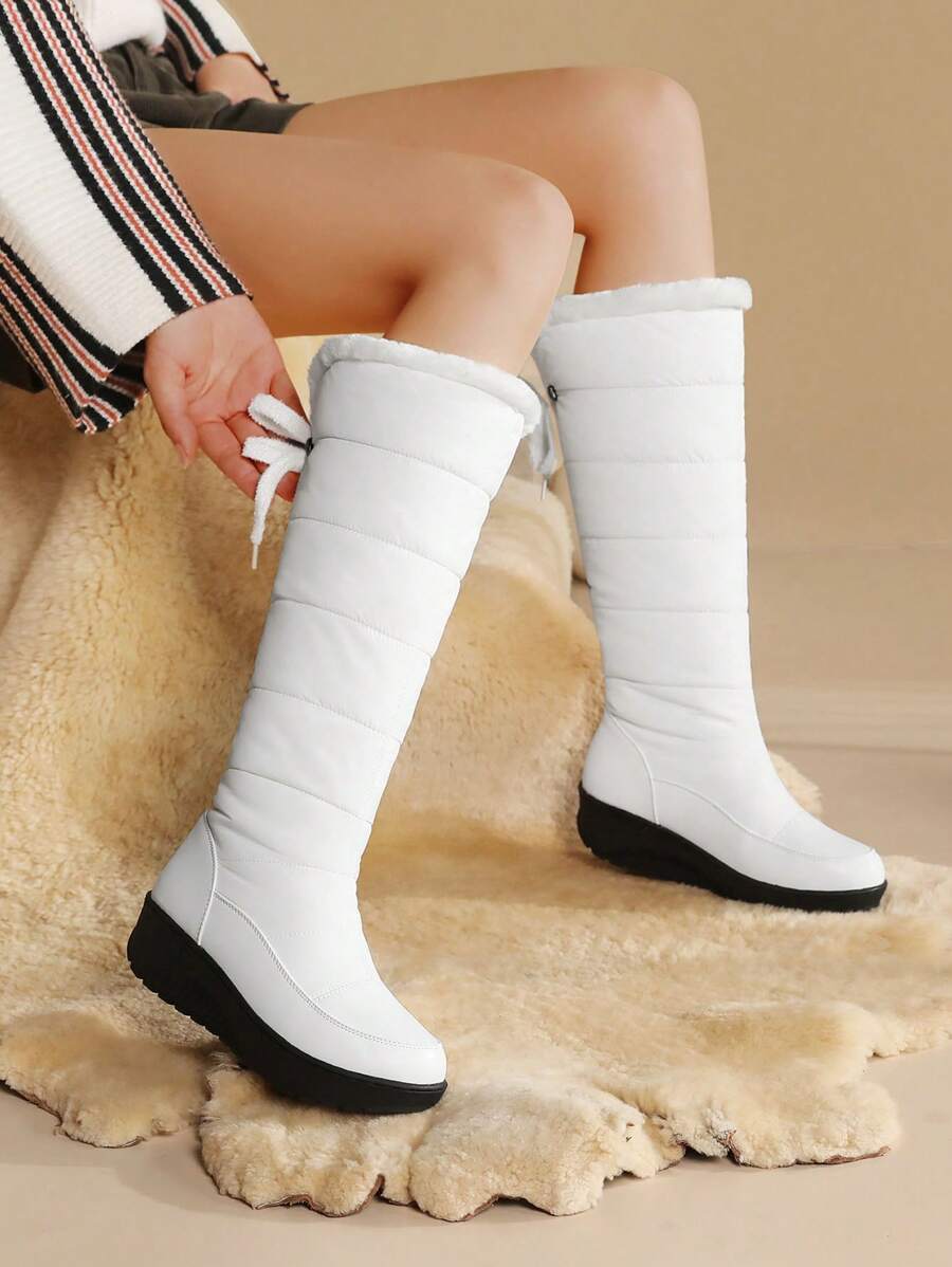 Step out in style and warmth with these playful knee-high snow boots! Featuring cozy fuzzy faux fur and waterproof platform wedge heels, they keep your feet dry and comfy all winter long. Perfect for snowy adventures or adding a chic touch to your cold-weather outfits.