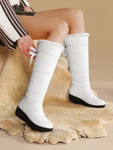 Step out in style and warmth with these playful knee-high snow boots! Featuring cozy fuzzy faux fur and waterproof platform wedge heels, they keep your feet dry and comfy all winter long. Perfect for snowy adventures or adding a chic touch to your cold-weather outfits.