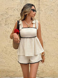 Front view of white cami and shorts set with black scalloped contrast trim