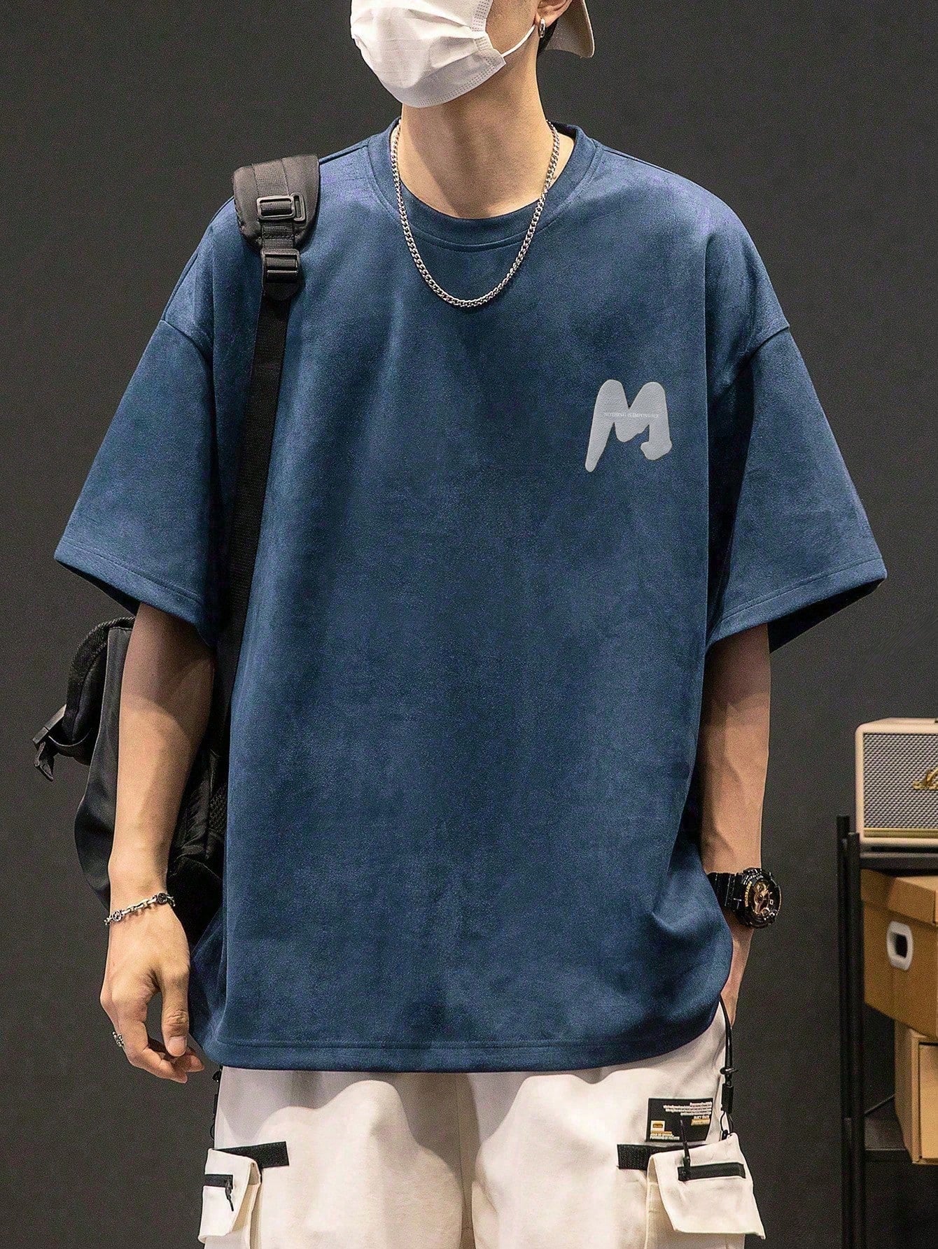 This tee is perfect for the cool and casual guy. The unique drop shoulder design adds a stylish twist to the classic graphic tee. Made with soft fabric, this tee is comfortable to wear all day long. Express yourself with the bold letter print and stand out from the crowd. (Casually cool tee with a unique drop shoulder design and bold letter print. Soft and comfy material for all-day wear.)