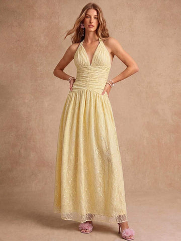 View 1 of butter yellow lace halter maxi dress with deep V neckline, ruched bodice, dropped waist, gathered full skirt, and back tie