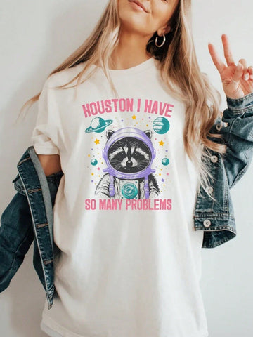 Unleash your cosmic side with our Vintage-Inspired Graphic Tee featuring a playful Cosmic Raccoon. Perfect for those who love quirky style! (Have you ever seen a raccoon in space?)