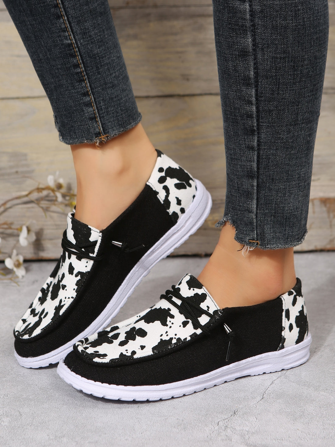 These stylish low-cut canvas sneakers for women feature a unique cow print design and durable lace-up closure. With a comfortable fit and trendy look, they are perfect for any casual occasion. Experience the perfect blend of style and function with these must-have footwear.