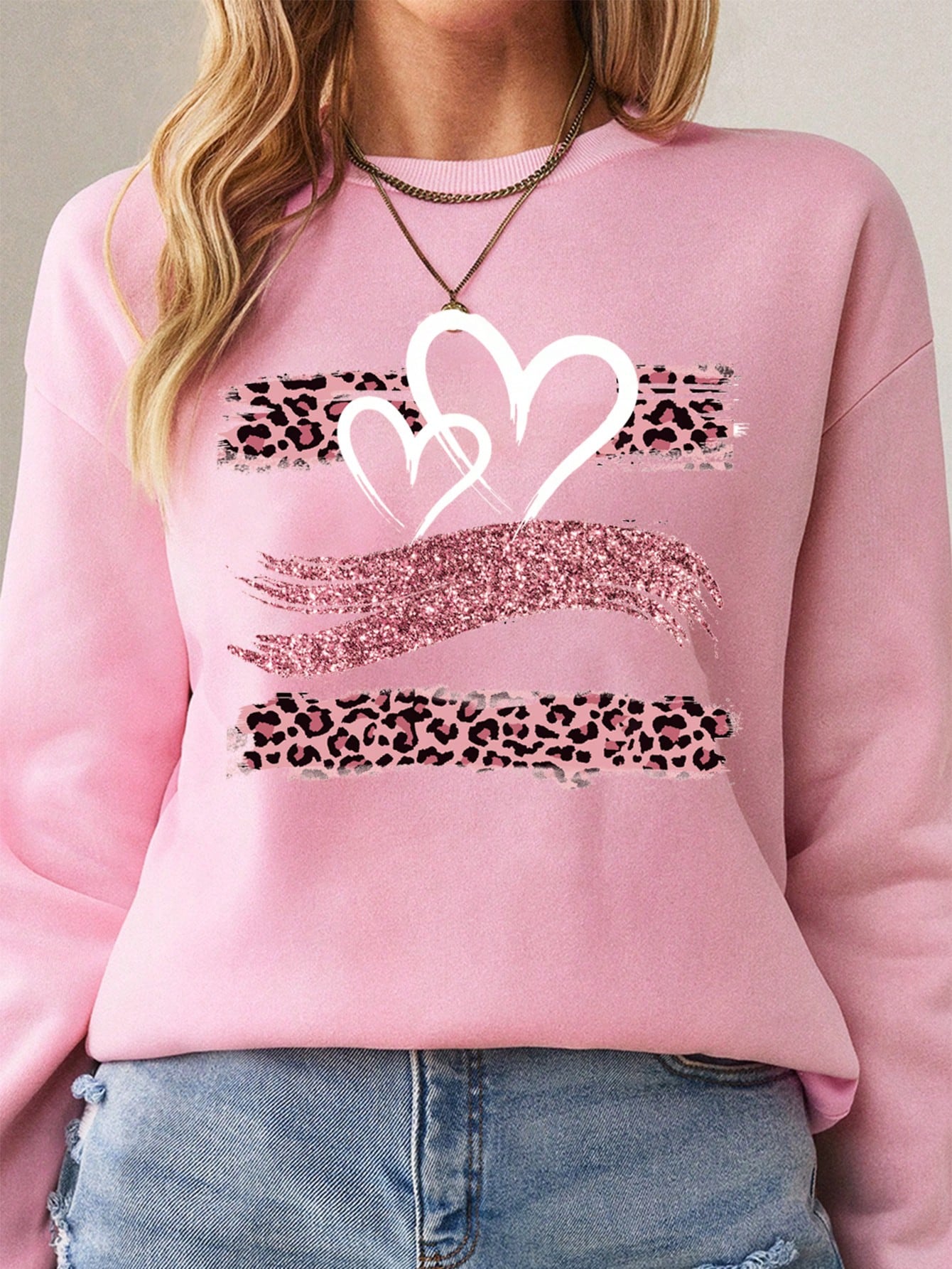 Stay warm and stylish this autumn with Cozy Chic's Heart & Leopard Print Sweatshirt. Made with soft, cozy fabric, this sweatshirt effortlessly combines comfort with fashion. The heart and leopard print design adds a touch of playfulness to your wardrobe. Experience effortless style and comfort with Cozy Chic.