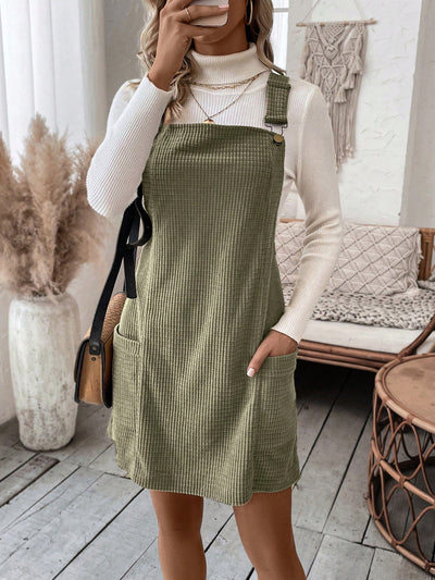 This Cozy Chic overall dress features a stylish plaid print and convenient pocket patches. Made with comfortable and soft materials, it is perfect for achieving a casual yet trendy look. Stay cozy and chic with this versatile and fashionable dress.