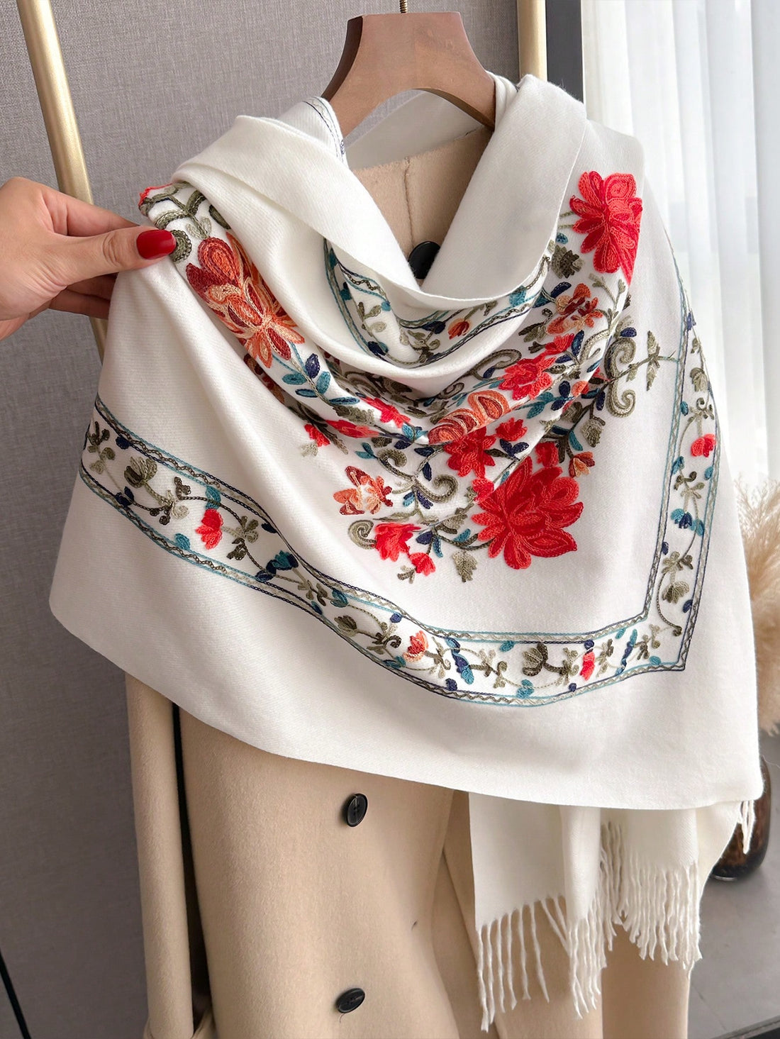 Stay warm and stylish with our Cozy Chic Poncho Scarf. Crafted with soft, faux cashmere and featuring an embroidered design, this hooded poncho scarf is the perfect accessory for any outfit. Complete with tassels for a playful touch. Stay comfy and chic all season long.