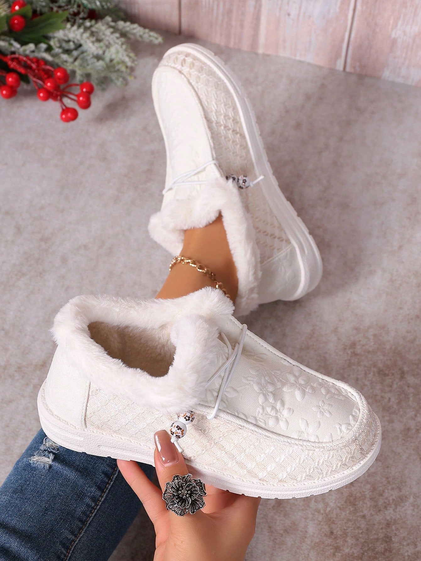 Stay warm and stylish with Cozy Chic: Women's Fleece-Lined Snow Boots. The fleece lining keeps your feet cozy while the fashion-forward beaded fur decor adds a touch of elegance. Perfect for cold weather, these boots offer both comfort and style.