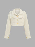 Front view of light cream cropped teddy jacket with collar, gold buttons and two flap chest pockets
