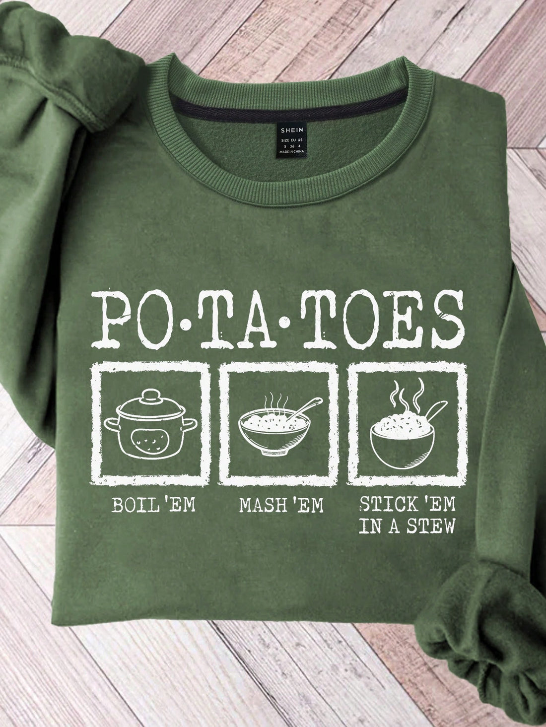 Stay warm and make everyone laugh this season with our 'Boil ‘Em, Mash ‘Em, Stick ‘Em in a Stew' Funny Potato Sweatshirt. Made with cozy materials, this comical sweatshirt is perfect for autumn and winter. Don't be a couch potato, stand out with this humorous and quirky piece!